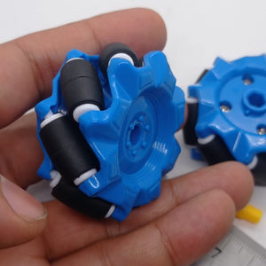 1 Piece 52mm Mecanum Omni Wheels Tires For DIY Rc Robot Toys Tt Motors - two blue plastic wheels with black rollers held in a hand, with a partial view of a ruler and a yellow component.