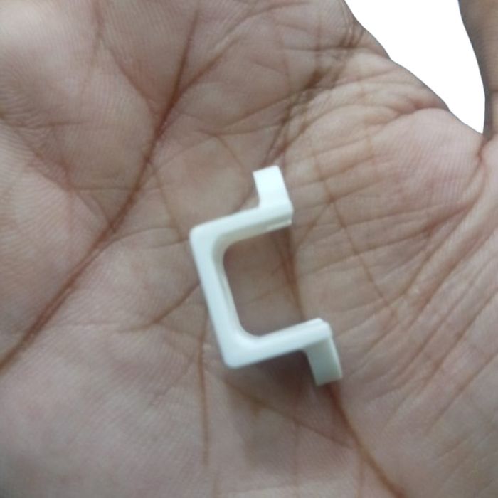 1 Piece N20 DC Gear Motor Mount Bracket - a close-up of the white plastic U-shaped mounting bracket held in a palm.