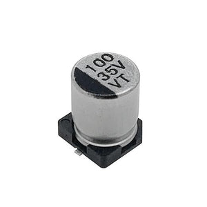 100uF 35V Vt SMD Capacitor | High-quality Surface Mount Capacitor | Digilog.pk - a silver cylindrical surface-mount electrolytic capacitor with a black base and markings reading 100, 35V, and VT.