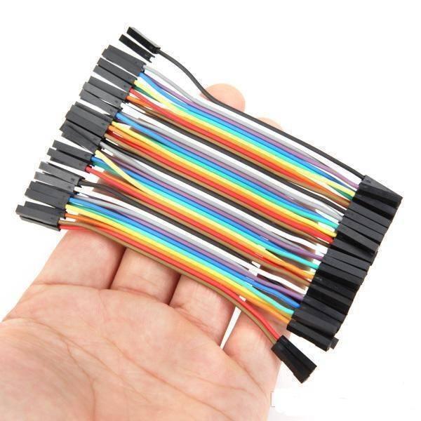 10cm Hole To Hole Jumper Wire Dupont Line 40 Pin Female To Female Arduino Jumper Wires - shown as a multi-coloured ribbon cable held in a human hand.