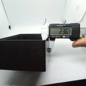 115mm x 90mm x 53mm ABS Electronics Enclosures Box Project Box - a digital caliper measuring the wall thickness of the black plastic rectangular case at 2.36mm.