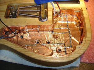 12mm One Sided Copper Foil Conductive Adhesive Tape - applied to the interior cavities of an electric guitar body for electromagnetic shielding.