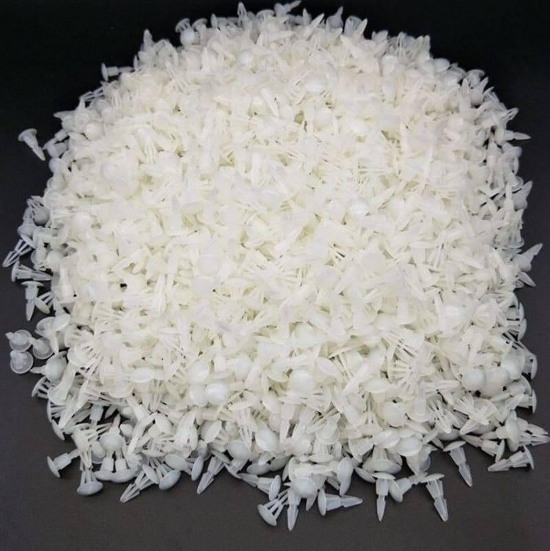 12mm Plastic PCB Circuit Board Spacer - shown as a large pile of small, white, translucent plastic fasteners against a black background.