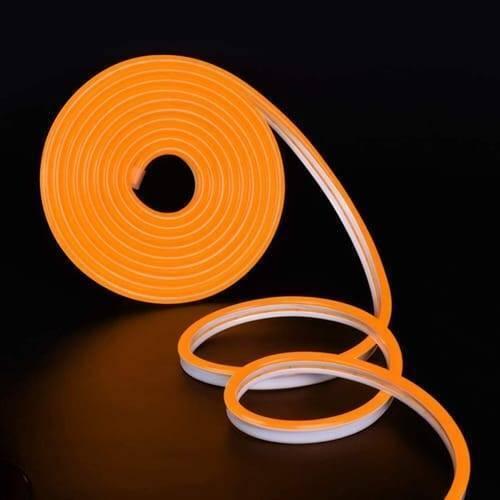 12V Orange Neon Flexible Strip Light 1m Waterproof SMD 5050 Rope String Silicone Lamp Outdoor Lighting - coiled into a circular roll on a black background, showing the orange silicone light strip and its white base.