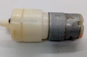 12V Water Cooler Pump stock lot - a side-view of a small cylindrical white plastic pump head attached to a grey metal DC motor.