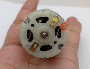 12V Water Cooler Pump stock lot - a close-up of the circular white plastic rear end with two metal terminals and a red positive polarity mark.