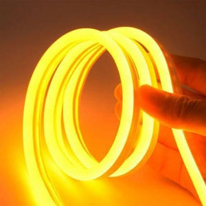 12V Yellow Neon Flexible Strip Light 1m Waterproof SMD 5050 Rope String Silicone Lamp Outdoor Lighting - shown as a coiled, glowing yellow silicone rope being held by a hand.