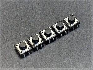 12x12x9mm Tactile Push Button Switch - a row of five square black tactile buttons with silver metal bases arranged diagonally on a grey surface.