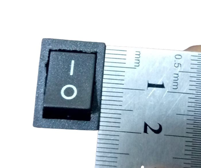 14MMX20MM 2 Position Rocker Switch 4 Legs - shown in a top-down close-up view being measured by a metal ruler.