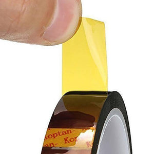 15mm Kapton High Temperature Heat Resistant Polyimide Film Adhesive Tape - a close-up of a finger pulling a yellow adhesive strip from a roll.