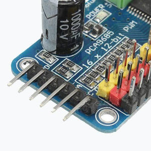16 Channel Servo Motor Driver PCA9685 12 Bit PWM I2c Module For Arduino - a close-up showing the blue circuit board, black capacitor, and multi-colored pin headers.