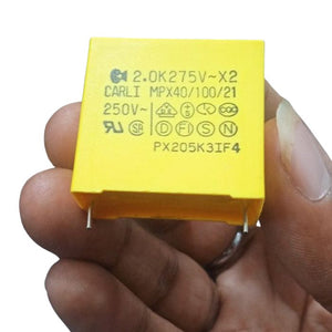 2.0uF 250VAC Capacitor - a close-up of a yellow rectangular film capacitor held in a hand, showing the printed technical specifications on its face.
