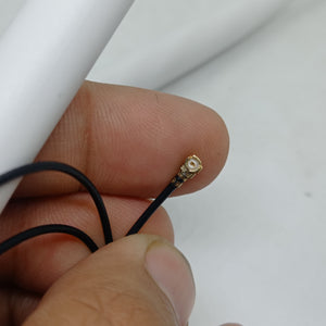 2.4GHz-5.8GHz 5db Wi-Fi Antenna With Ipex Connector - close-up of a hand holding the small gold-colored Ipex connector attached to a thin black cable.