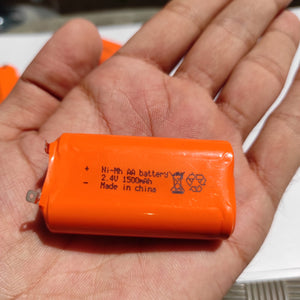 2.4V 1000mAh AA Long-lasting Rechargeable Battery - an orange cylindrical battery pack held in a hand with visible text and polarity markings.