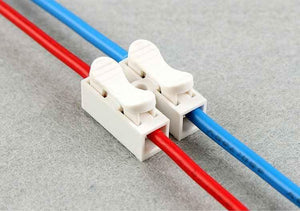 2 Point Quick Connector Cable Clamp Terminal Block Spring Connector Wire - two white plastic connectors with levers clamping red and blue wires.