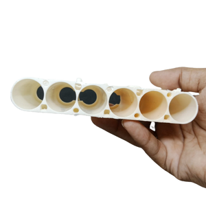 20700A Cell Holder dyson - a cream-colored plastic bracket with six cylindrical slots held in a hand.