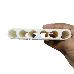 20700A Cell Holder dyson - a white plastic bracket with six circular slots held by a hand.
