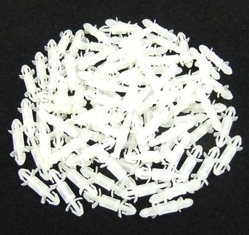 20mm Xlb Nylon PCB Board Rivet Spacer - shown as a pile of multiple small, white, cylindrical plastic fasteners with locking tabs on both ends.