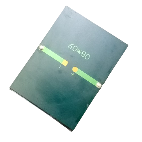 Mini Solar 60x80mm 0.50V - a rectangular dark green solar panel with a central gold-coloured contact point labeled with plus and minus symbols.
