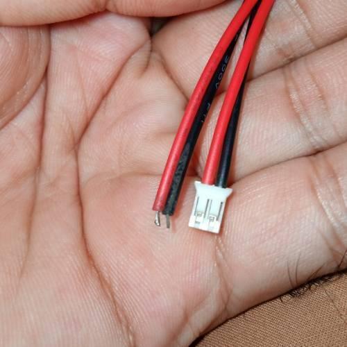 2mm Pitch JST2.0 Plug 2 Pin Extension Wire Connector - a close-up of a white two-pin connector with red and black wires held in a hand.