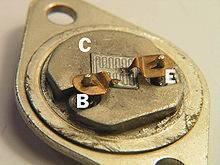 2N3055 Transistor - a close-up view of the internal silicon die and wire bond connections labeled B, C, and E inside a metal TO-3 package.