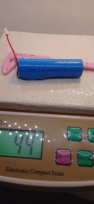 3.7V 1800mAh 18650 Lithium-ion Battery Pack With BMS Protection – Buy - red connector cable, placed on a scale displaying 44g next to a pink plastic caliper.