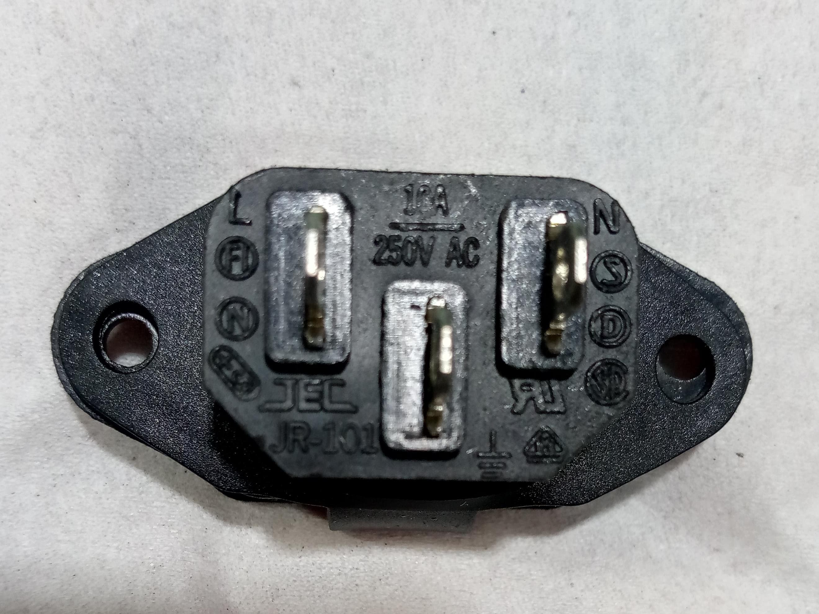 3 Pin Male Computer Socket AC Socket With Closing Window - black panel-mount power connector showing three metal pins and molded labels for L, N, and ground.