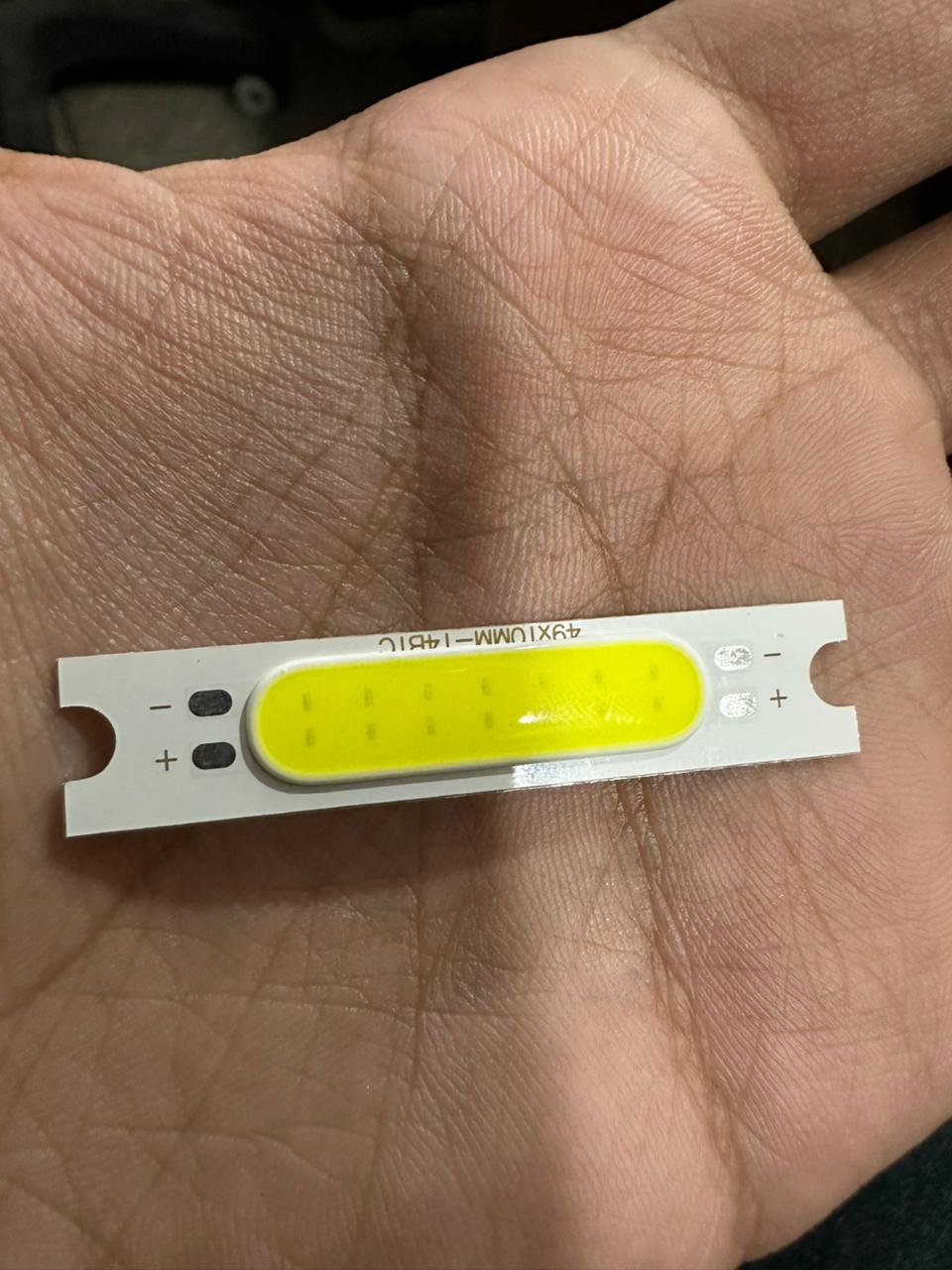 3W 3.7V 1000mA 300LM LED COB Light Module - shown as a rectangular white circuit board with a yellow light-emitting strip and positive and negative terminals.