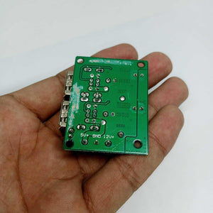 4 USB Port A5268 Chip Step Down Transformer Converter Board Module DC 12V 24V 40V To 5V 5A 25W For MP3/MP4 Phone Car Equipment - green circuit board held in a hand showing the underside with 5V, GND, and 12V labeled solder pads.