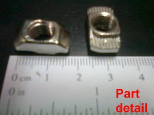 40XM8 T Nut Sliding T Nut Hammer Drop In Nut Fasten Connector M8 Series - shown as a close-up of two silver metal nuts next to a metric ruler.