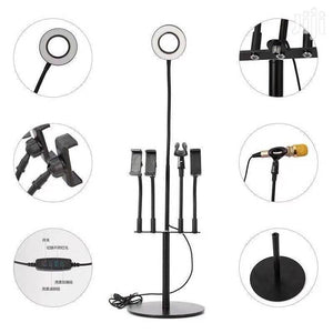 5 In 1 Multi Function Live Stream Support Kit - a black stand with a ring light, four phone holders, a microphone mount, and a wired control remote.