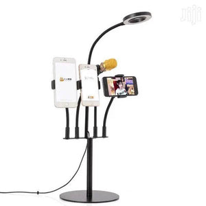 5 In 1 Multi Function Live Stream Support Kit - a black stand with a ring light, a gold microphone, and three phone holders holding mobile devices.