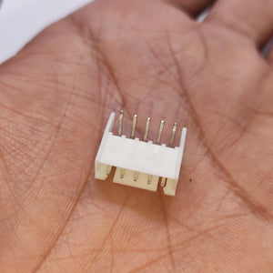 5 Pin Right Angle Male 2.5mm JST Xh Style PCB Mount Connector - shown as a close-up of the white plastic housing and metal pins held in a palm.