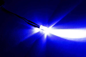5mm Blue LED - a single, clear-encased light-emitting diode glowing with a bright blue light, attached to two black wires.