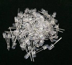 5mm White LED Light Bulb - a large pile of clear, round-top light-emitting diodes with two metal pins each on a black background.