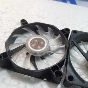 5V Fan With LED - a close-up of two black square cooling fans with translucent blades and visible internal copper coils at the center.