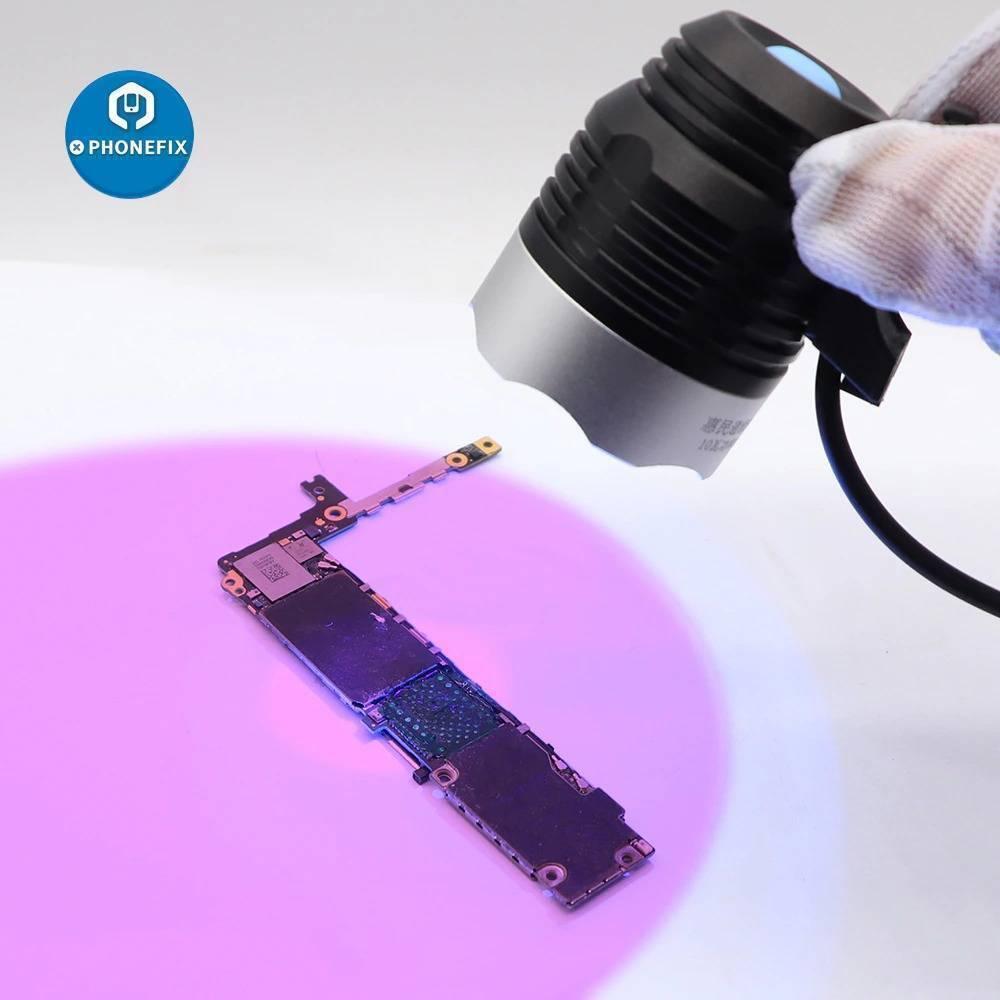 5V USB UV Glue Lamp LED Ultraviolet Green Oil Curing Purple Light - casting a purple light onto a smartphone circuit board.
