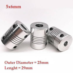5x6mm Flexible Coupling Shaft With 25mm Outer Diameter - three silver cylindrical metal couplers with grooved bodies and small black set screws on a white background.