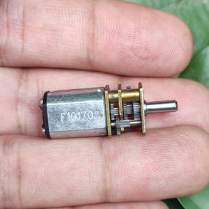 68RPM N20 DC Gear Motor - a close-up showing a silver metal motor with a brass-coloured gearbox and output shaft held between two fingers.
