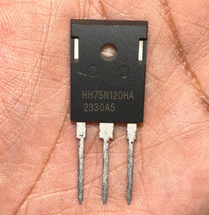 75amps 1200volts HH75N120HA IGBT Solar Inverter IGBT-digilog.pk - close-up view of a black, rectangular electronic component with three metal pins held in a person's palm.