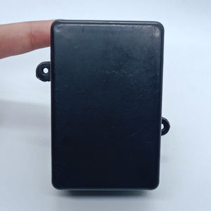 87mm x 55mm X33MM ABS Box PCB Enclosure Plastic Box Project Box - a plain black rectangular plastic project box with two mounting tabs on the sides, held by a finger.