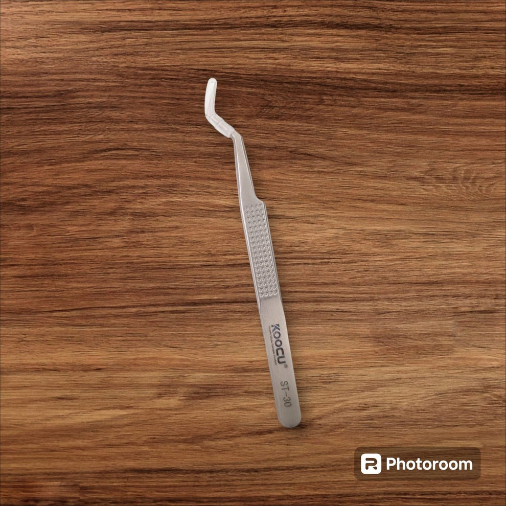 Koocu St-30 Non-magnetic Stainless Steel Precision Chip Placement Tweezer - with a curved tip, shown lying flat on a brown wooden surface.