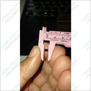 Pink caliper measuring a small black SS56 diode in DO-214AA package in Pakistan
