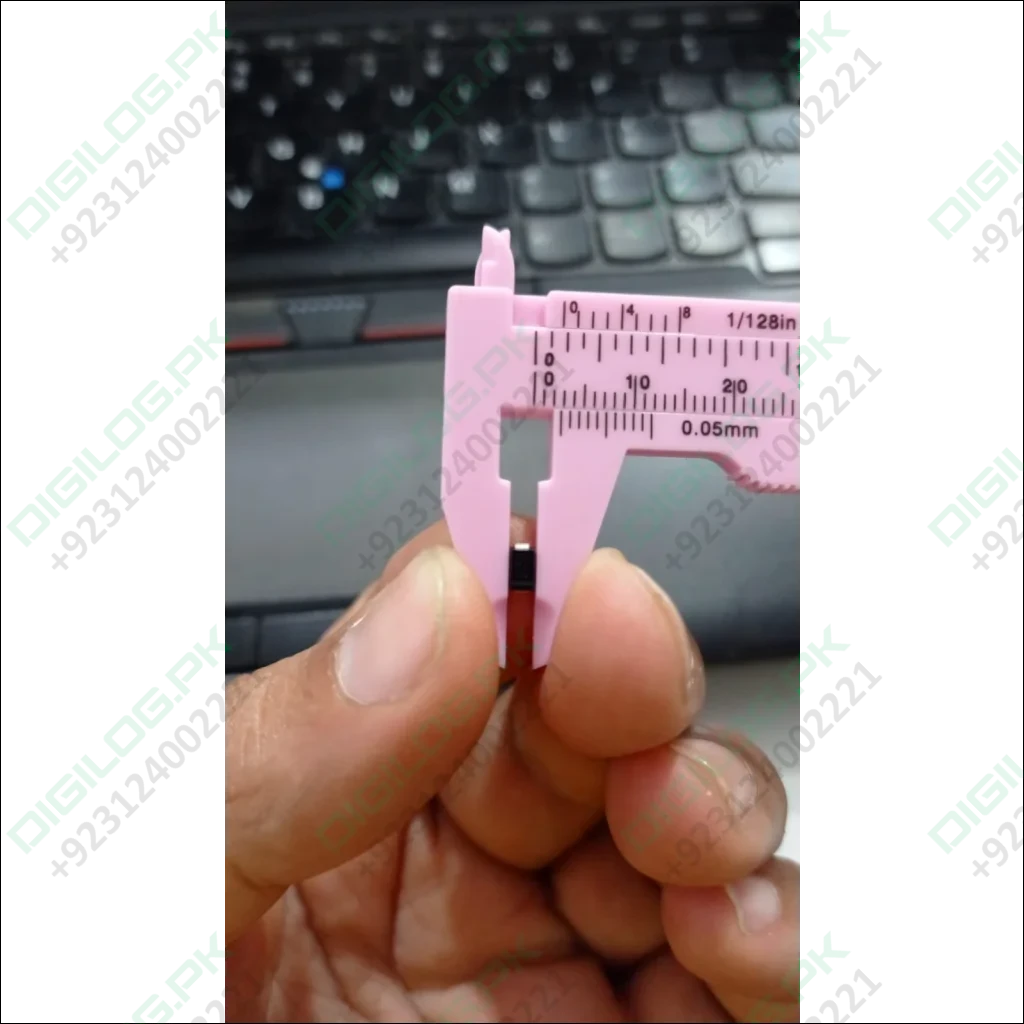 Pink caliper measuring SS56 diode in DO-214AA package, showcasing precision
