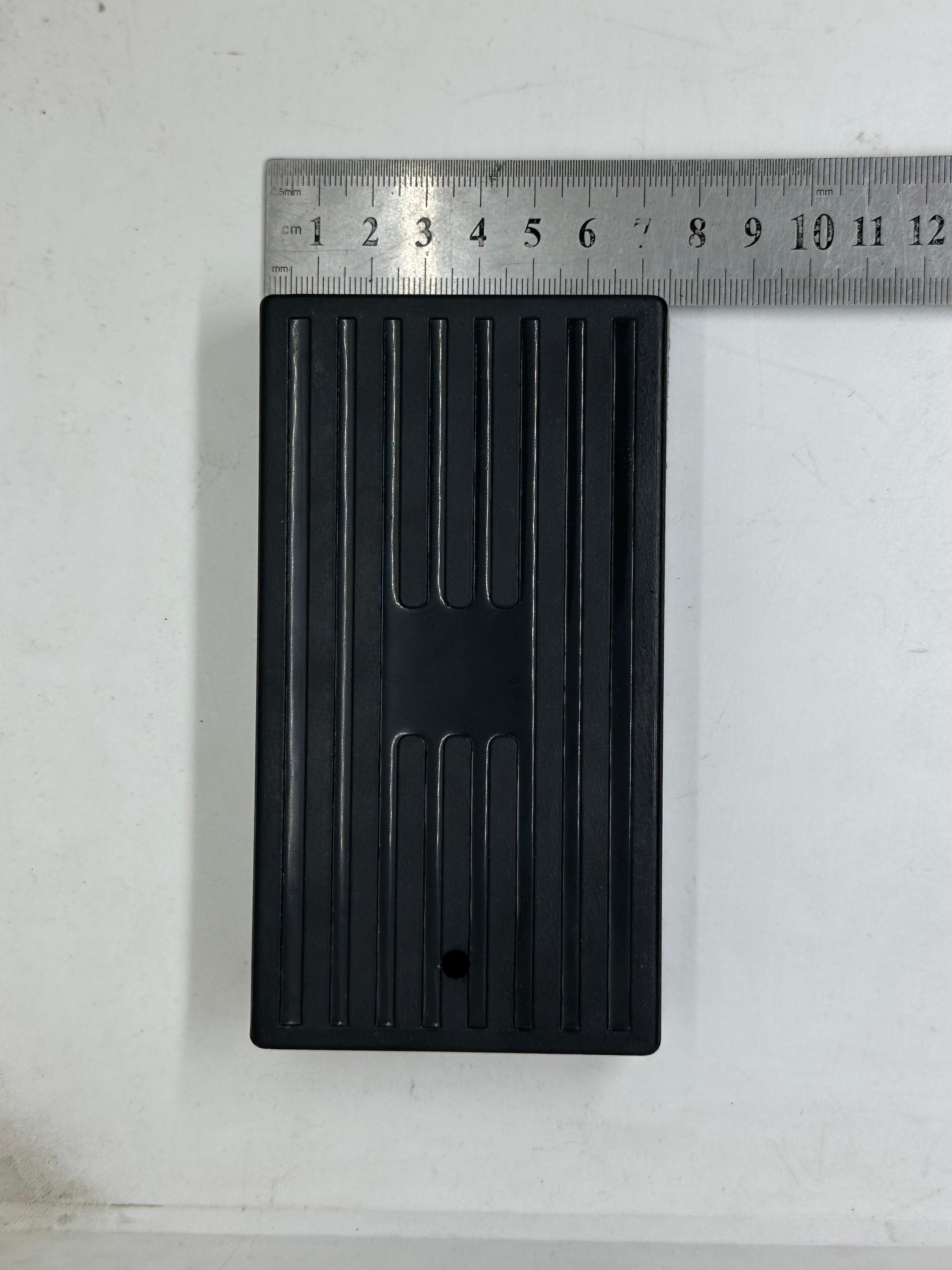 ABS Enclosure Box For WiFi Router - shown in black with a rectangular design, ribbed surface, and a single circular hole, measured against a metal ruler.