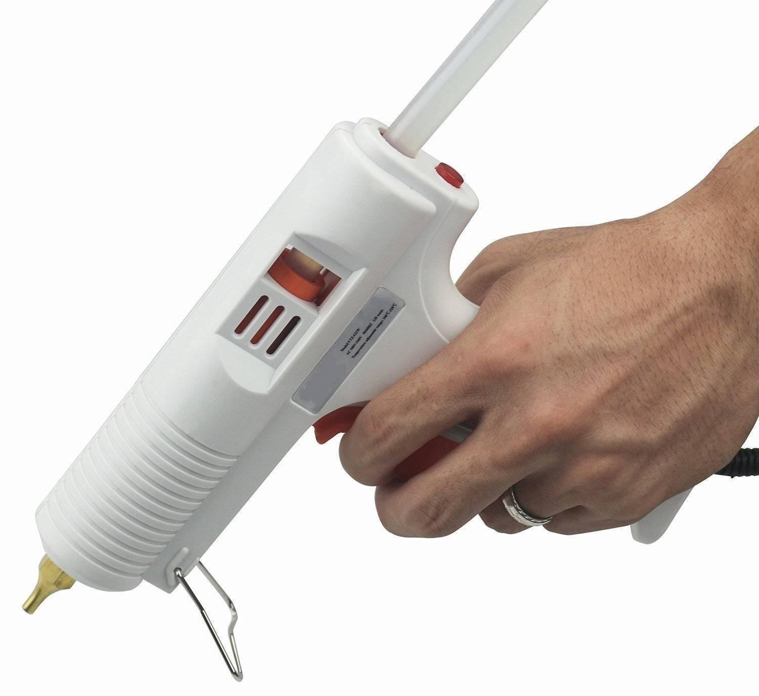 Adjustable Temperature Hot Glue Gun - shown in a white plastic housing with a red trigger, a red power switch, and a glue stick inserted in the rear.