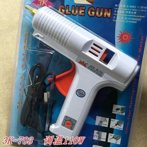 Adjustable Temperature Hot Glue Gun - in its original retail packaging, featuring a white body, an orange temperature control dial, and a black power cord.