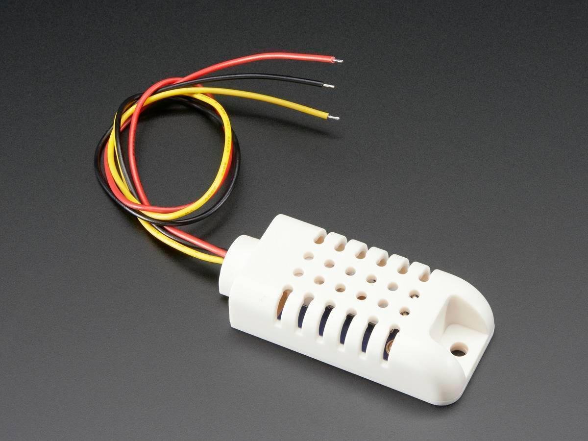 AM2302 Temperature And Humidity Sensor - a white plastic casing with ventilation holes and three attached red, black, and yellow wires.
