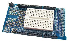 Arduino Mega Proto Shield - a blue circuit board with a white breadboard, a reset button, ICSP header, and various labeled pin headers.