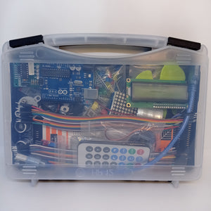 Arduino Starter Kit - clear plastic carrying case containing an Arduino Uno board, an LCD screen, a remote control, jumper wires, and components.